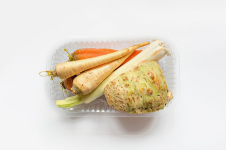 Vegetables from local market in plastic shopping box over light background. Top view. Organic food. Plastic Pollution, Ethical Consumerism.の写真素材