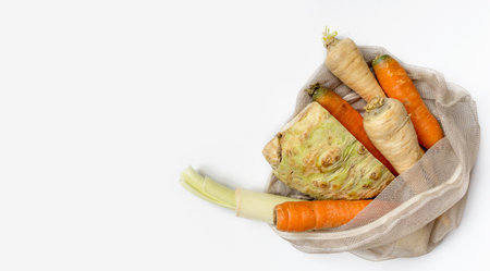 Vegetables set from local market in reusable shopping bag over light background. Copyspace. Top view. Organic food, edible fresh picked. Plastic Pollution, Ethical Consumerism, Healthy Eating concept.の写真素材