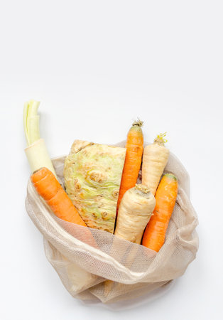 Vegetables set from local market in reusable shopping bag over light background. Copyspace. Top view. Organic food, edible fresh picked. Plastic Pollution, Ethical Consumerism, Healthy Eating concept.の写真素材