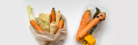 Vegetables from local market in reusable shopping bag and rotten spoiled vegetables in plastic shopping bag over light background. Top view. Organic food. Plastic Pollution, Ethical Consumerism.の写真素材