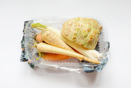 Vegetables from local market in plastic shopping box over light background. Top view. Organic food. Plastic Pollution, Ethical Consumerism.の写真素材