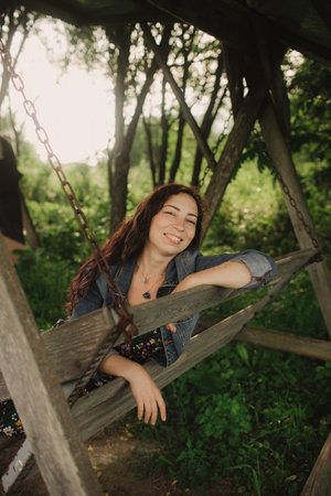 Calm woman enjoying the moment and slow life at her eco-farm. Concept green tourism, slow life, gardening, eco friendly. Part of the series.の写真素材