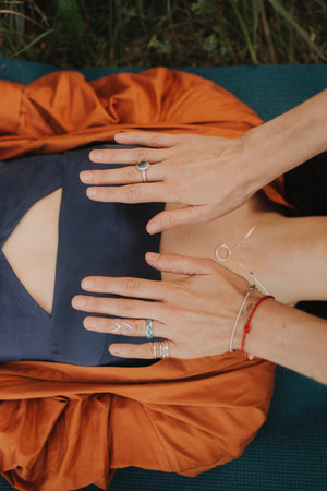 Female energy massage relaxing and care treatment for body and mind full health gentle woman arms holding head doing access bars. Unity with nature and wellness concept. Part of the series.の写真素材