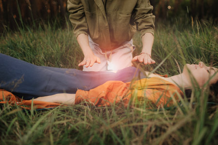 Female energy massage relaxing and care treatment for body and mind full health gentle woman arms holding head doing access bars. Unity with nature and wellness concept. Part of the series.の写真素材