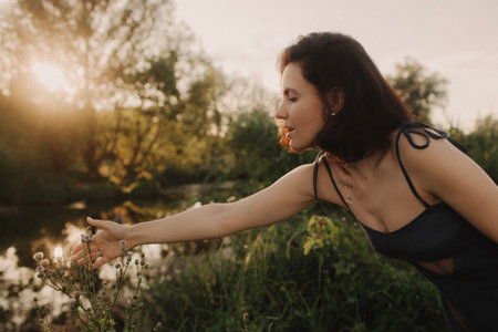 Overjoyed happy woman enjoying the green beautiful nature around her - concept of female people and...