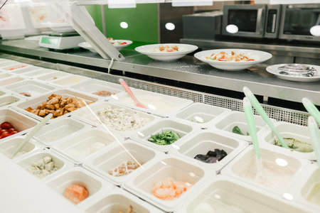 Modern restaurant with different ingredients for creating a dish in metal warm containers on the counter. Catering and buffet concept.の写真素材