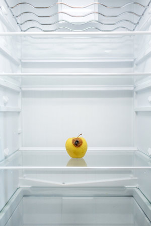 Moldy spoiled apple in the refrigerator. Improper storage, spoiled product, expired concept. Part of a series.の写真素材