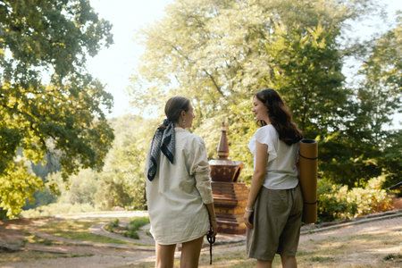 Mentor and student before Mindful meditation and yoga in an open area. Deep relaxation and inner contemplation of people. Facilitating meditative experience. Part of the series.の写真素材