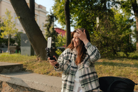 Vlogger traveler woman recording video on phone camera share via app her travel vacation in the...