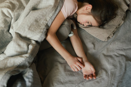 A sick child with skin rashes in bed. Child's skin with many red spot. Allergic reaction, Drug allergy, Scarlet fever, Atopic dermatitis, Diaper rash, Urticaria, Scabies, Heat rash. Part of a series.の写真素材