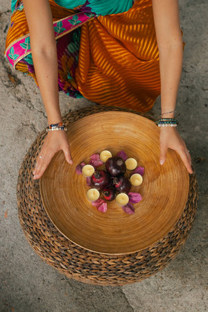 Close-up Indian Woman in traditional saree lighting Diya lamp during Diwali festival. Happy greeting...