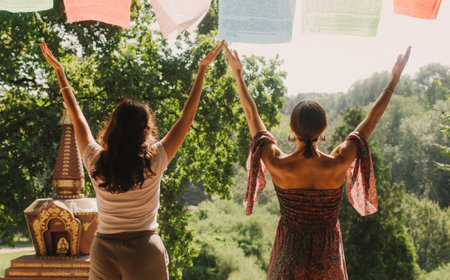 Close up of female mentor and student before Mindful meditation and yoga in the gazebo. Facilitating meditative experience. Part of the series. Tibetan singing bowl. Soft focus, blurred, noise effectの写真素材