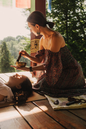 Close up of female mentor and student before Mindful meditation and yoga in the gazebo. Facilitating...