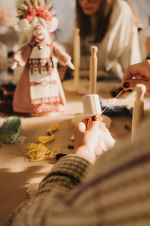 Ukrainian traditional Motanka doll in national costume. Master class on making traditional symbol. Nation code. Cultural heritage. Craft amulet. Patriotic handicrafts. Part of the series. Soft focusの写真素材