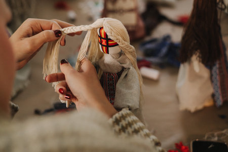 Ukrainian traditional Motanka doll in national costume. Master class on making traditional symbol. Nation code. Cultural heritage. Craft amulet. Patriotic handicrafts. Part of the series. Soft focusの写真素材