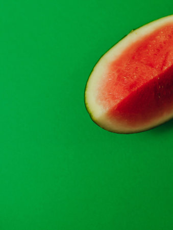 Fresh watermelon on green background. Healthy raw food, dessert without sugar and flour. For text and articles on health. The concept of zero waste, pesticide-free and eco-friendlyの写真素材