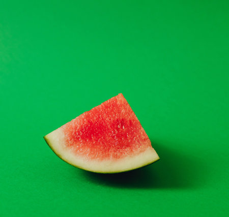 Fresh watermelon on green background. Healthy raw food, dessert without sugar and flour. For text and articles on health. The concept of zero waste, pesticide-free and eco-friendlyの写真素材