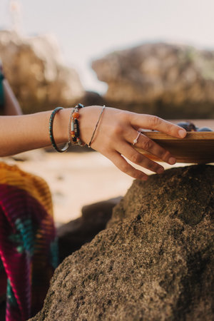 Close up of Indian woman's hands in traditional jewelry on the nature. Indian festival costume....