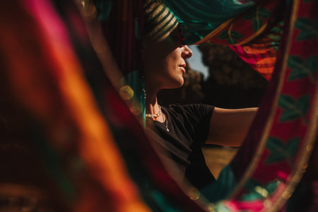 Close-up portrait of Indian woman in traditional clothes dancing on the nature with the ocean on background. Indian festival costume. Concept of solo tourism and travel to India. Part of a seriesの写真素材