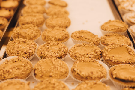 Close-Up fresh Pastel de Nata in the window of a bakery in Lisbon, Portugal. Solo tourism and travel. Part of a seriesの写真素材