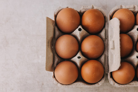 Organic Brown eggs in tray or egg box. Poultry Chicken eggs in carton for grocery or breakfast. Hen farm eggshells collected arranged packaged for sale. Soft focus. Part of a seriesの写真素材