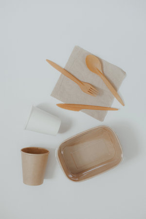 Eco friendly, disposable, recyclable, compostable tableware. Paper food boxes, dishes on light background. Sustainable lifestyle and PLASTIC FREE concept. Flat lay Earth tones with place for textの写真素材
