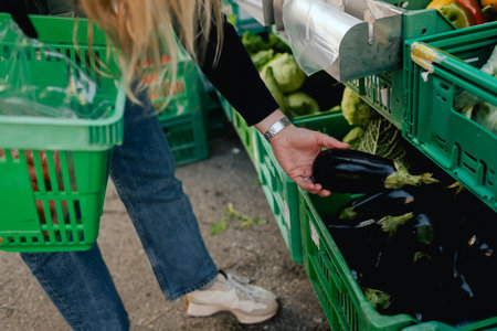 Close up of hands buying vegetables on the local Farmers market. Customer shopping at Farmers Market Stall. Part of the series.の写真素材