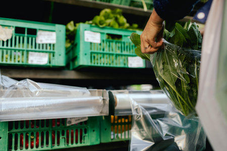 Close up of hands buying greens and vegetable on the local Farmers market. Customer Shopping At Farmers Market Stall. Part of the series.の写真素材