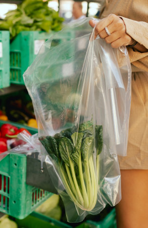 Close up of hands buying greens and vegetable on the local Farmers market. Customer Shopping At Farmers Market Stall. Part of the series.の写真素材
