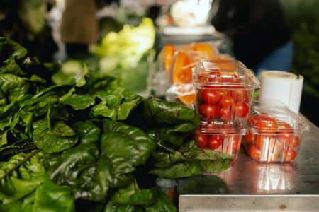 Fresh vegetables at small local urban market. Organic produce on sale at outdoor farmer market. Selling fresh crops and veggies harvest. European urban setting. Close up. Part of the series.の写真素材