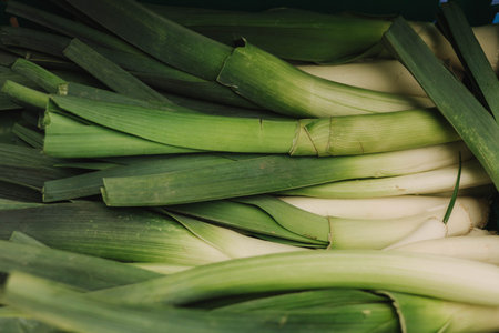 Close up of green leek on the local Farmers market. Shopping At Farmers Market Stall. Close up. Part of the series.の写真素材