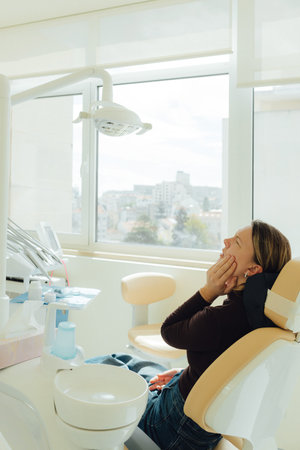 Middle-aged woman, teeth and dentist for dental care, appointment or checkup at clinic. Tooth whitening, cleaning or oral, mouth and gum care at hospital. Soft focus. Part of a series. Close-up.の写真素材