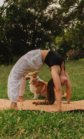 Fit sporty mindful young woman meditating, doing yoga and breathing exercises with eyes closed,...