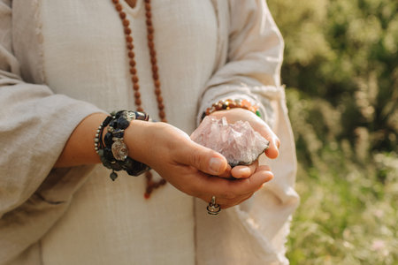 Close-up of female hands holding natural healing stones. Tools for energy balance, emotional support, self-discovery through intention, intuition, gentle presence. Vintage tone. Soft focus, blurred.の写真素材
