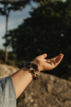 Close-up of female hands holding natural healing stones. Tools for energy balance, emotional support, self-discovery through intention, intuition, gentle presence. Vintage tone. Soft focus, blurred.の写真素材