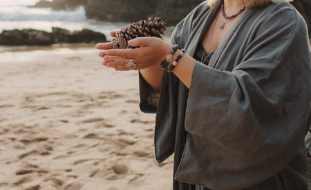 Close-up of female hands holding natural healing stones. Tools for energy balance, emotional support, self-discovery through intention, intuition, gentle presence. Vintage tone. Soft focus, blurred.の写真素材