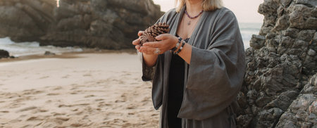 Close-up of female hands holding natural healing stones. Tools for energy balance, emotional support, self-discovery through intention, intuition, gentle presence. Vintage tone. Soft focus, blurred.の写真素材