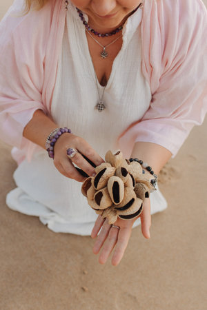 Close-up of female hands holding sound healing instruments. Tools for therapy, inner balance, and self-discovery through vibration, intention, and deep presence. Vintage tone. Soft focus, blurred.の写真素材
