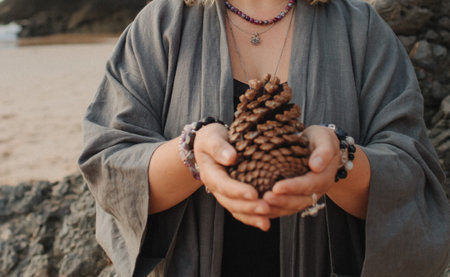 Close-up of female hands holding natural healing stones. Tools for energy balance, emotional support, self-discovery through intention, intuition, gentle presence. Vintage tone. Soft focus, blurred.の写真素材