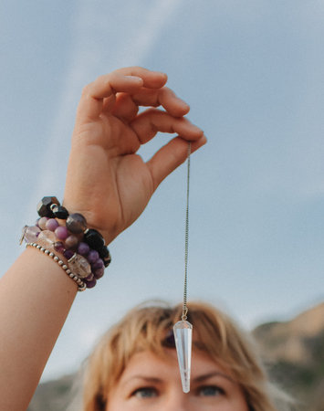Close-up of female hands holding natural healing stones. Tools for energy balance, emotional support, self-discovery through intention, intuition, gentle presence. Vintage tone. Soft focus, blurred.の写真素材