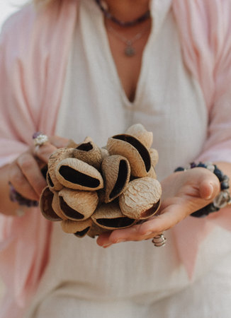 Close-up of female hands holding sound healing instruments. Tools for therapy, inner balance, and self-discovery through vibration, intention, and deep presence. Vintage tone. Soft focus, blurred.の写真素材