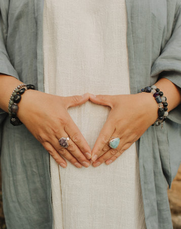 Close-up of female hands holding natural healing stones. Tools for energy balance, emotional support, self-discovery through intention, intuition, gentle presence. Vintage tone. Soft focus, blurred.の写真素材