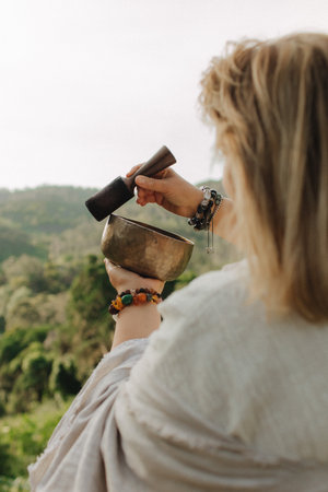 Close-up of female hands holding sound healing instruments. Tools for therapy, inner balance, and self-discovery through vibration, intention, and deep presence. Vintage ton. Soft focus, blurred.の写真素材