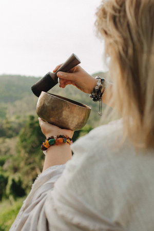 Close-up of female hands holding sound healing instruments. Tools for therapy, inner balance, and self-discovery through vibration, intention, and deep presence. Vintage ton. Soft focus, blurred.の写真素材