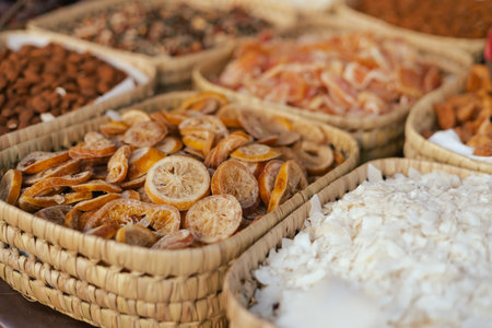 Dried fruit on sale at outdoor farmer market. The fruit shrinks during this process, leaving a...
