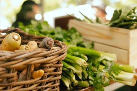 Fresh greens at small local urban market. Organic produce on sale at outdoor farmer market. Selling...