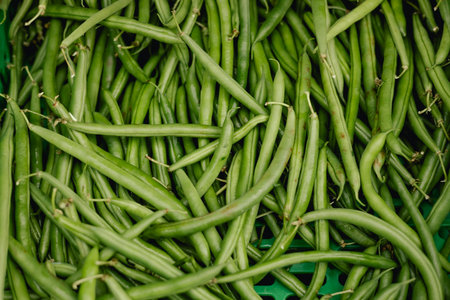 Fresh greens at small local urban market. Organic produce on sale at outdoor farmer market. Selling...