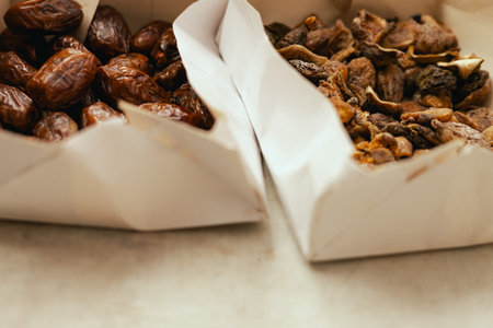 Dried dates on sale at outdoor farmer market. The fruit shrinks during this process, leaving a...