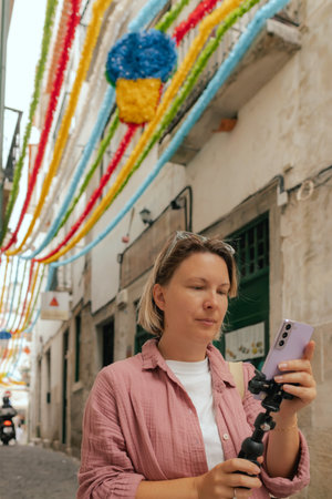 Vlogger traveler woman recording video on phone share via app travel vacation. Middle age woman...