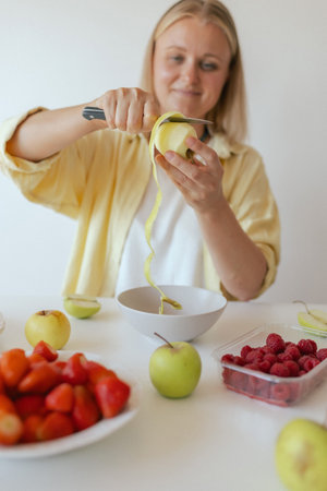 Mature woman serving herself wholesome vegan food at home. Woman taking care of her aging body with...